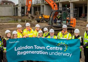 Sanctuary staff members and Councillors pose at the Laindon site with a banner that reads 'Laindon Town Centre Regeneration underway'
