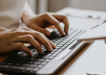 A close up of someone typing on a keyboard
