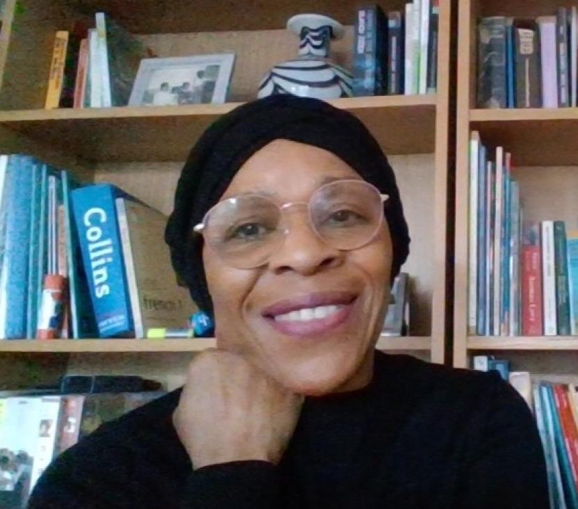 Portrait photo of Georgia Blackwood sat in front of a bookcase.